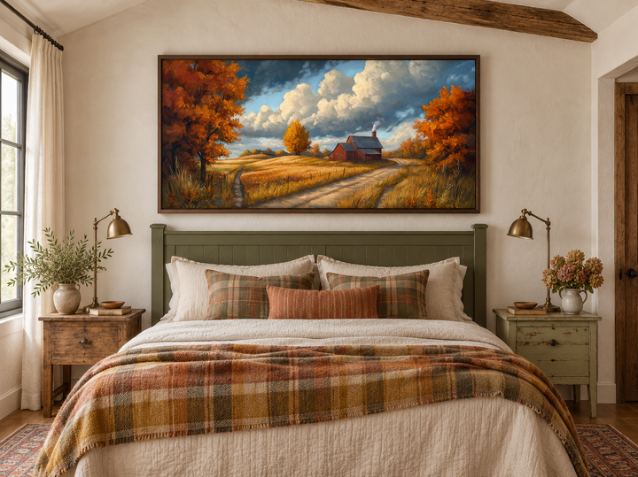 Rustic autumn barn landscape wall art in a walnut frame above a cozy farmhouse bed.