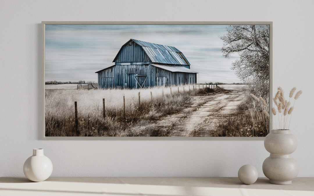 Rustic blue barn canvas wall art in a wooden frame displayed above a shelf with neutral decor.
