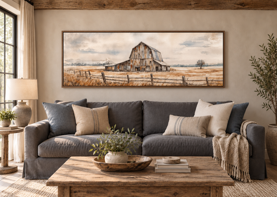 Rustic barn horizontal canvas print in a walnut frame above a charcoal sofa in a farmhouse room.