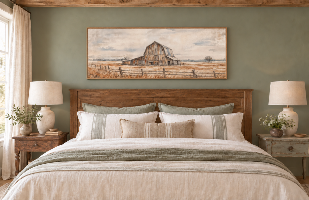 Rustic barn wall art in a long horizontal frame above a bed in a neutral farmhouse bedroom.