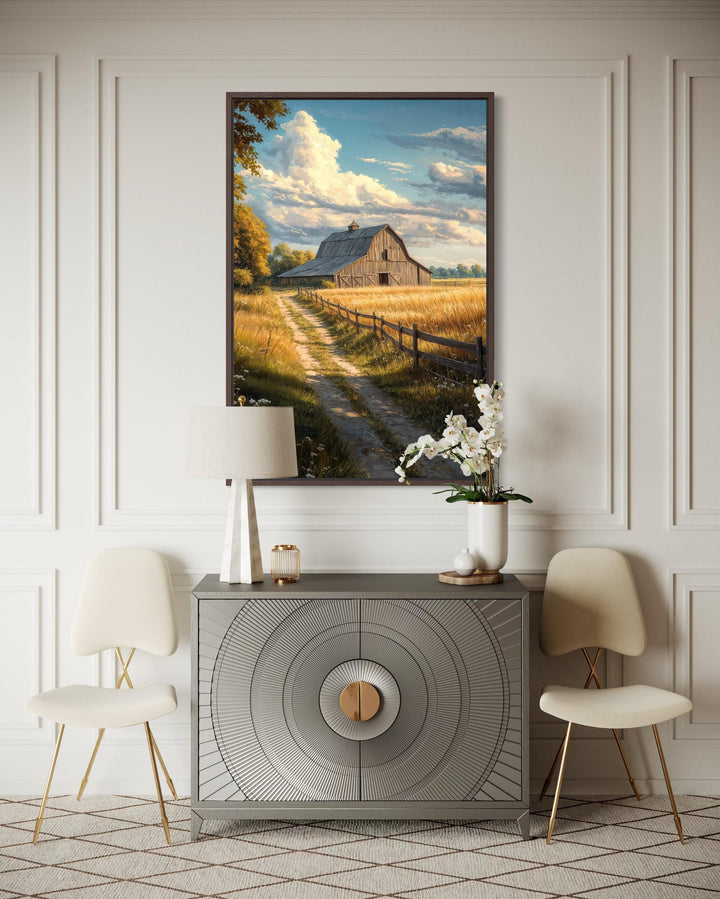 Vertical canvas print of a rustic barn in a golden field landscape above a modern sideboard.