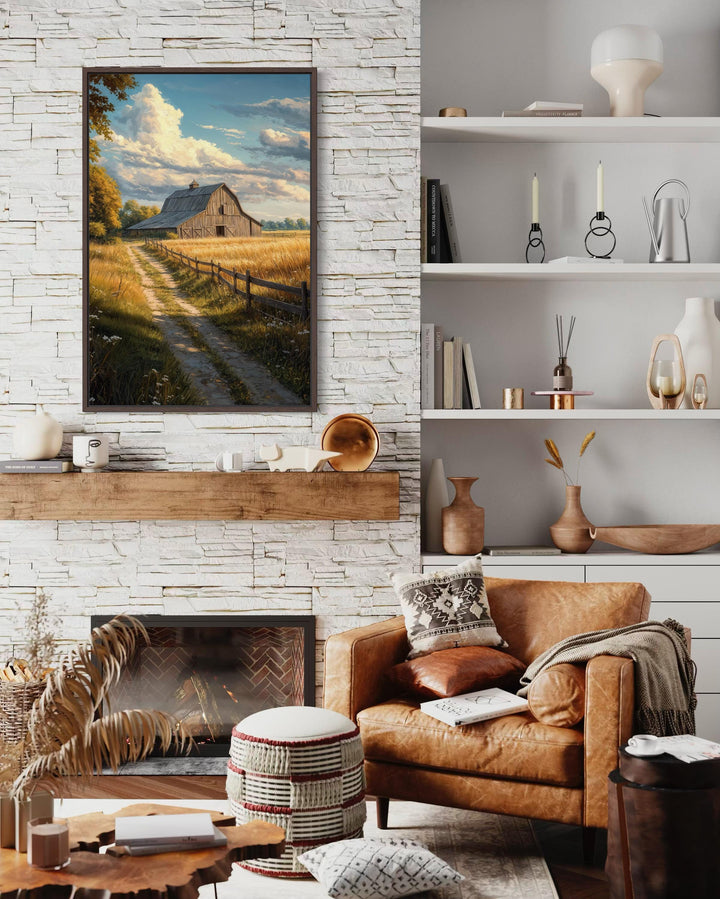 Vertical canvas print of a rustic barn in a golden field landscape above a stone fireplace.