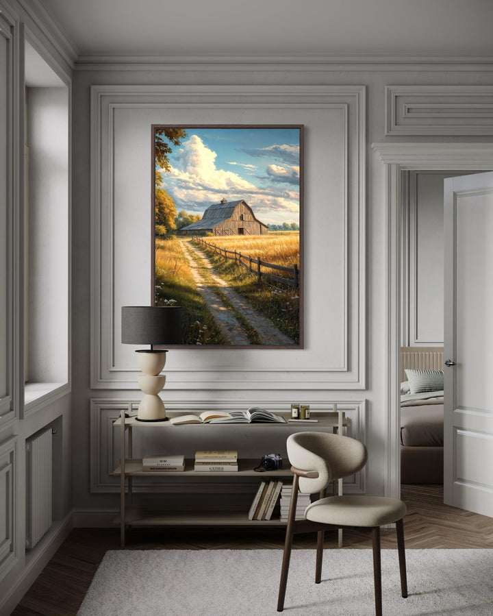 Vertical canvas print of a rustic barn in a golden field landscape on a white paneled wall.