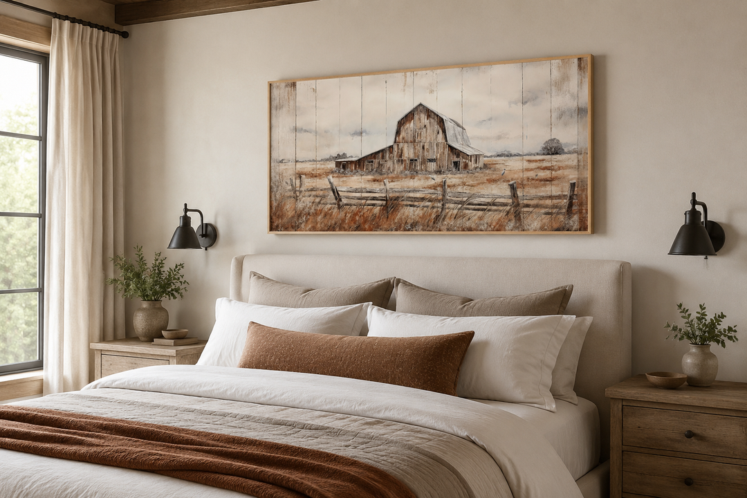 Rustic weathered barn wall art canvas in a wooden frame above a neutral farmhouse bed.
