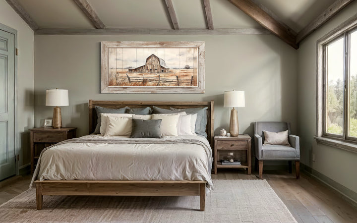 Rustic barn wall art in a weathered frame hanging above a wooden bed in a farmhouse bedroom.