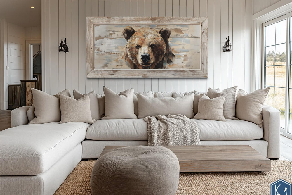 Rustic bear portrait on a distressed wood-effect framed canvas above a large neutral sectional sofa.