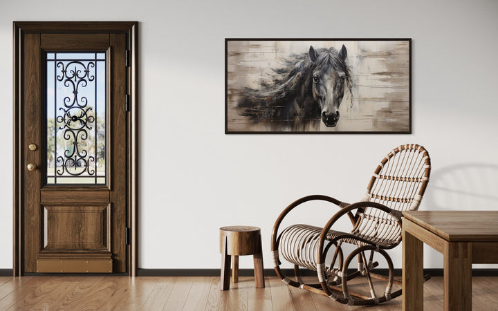 Rustic black horse painting on a wood-textured canvas, framed and hung in a farmhouse-style room.