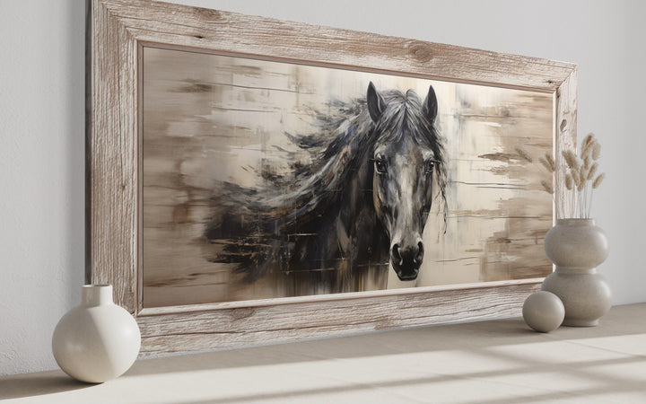 Rustic black horse painting on a wood-textured canvas in a light wood frame for farmhouse decor.