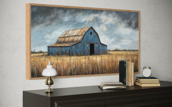 Rustic blue barn framed canvas wall art above a dark wood dresser with vintage decor.