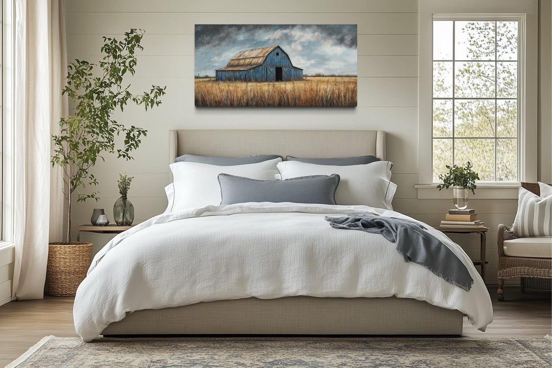 Rustic blue barn canvas wall art hanging above a bed in a farmhouse-style bedroom.