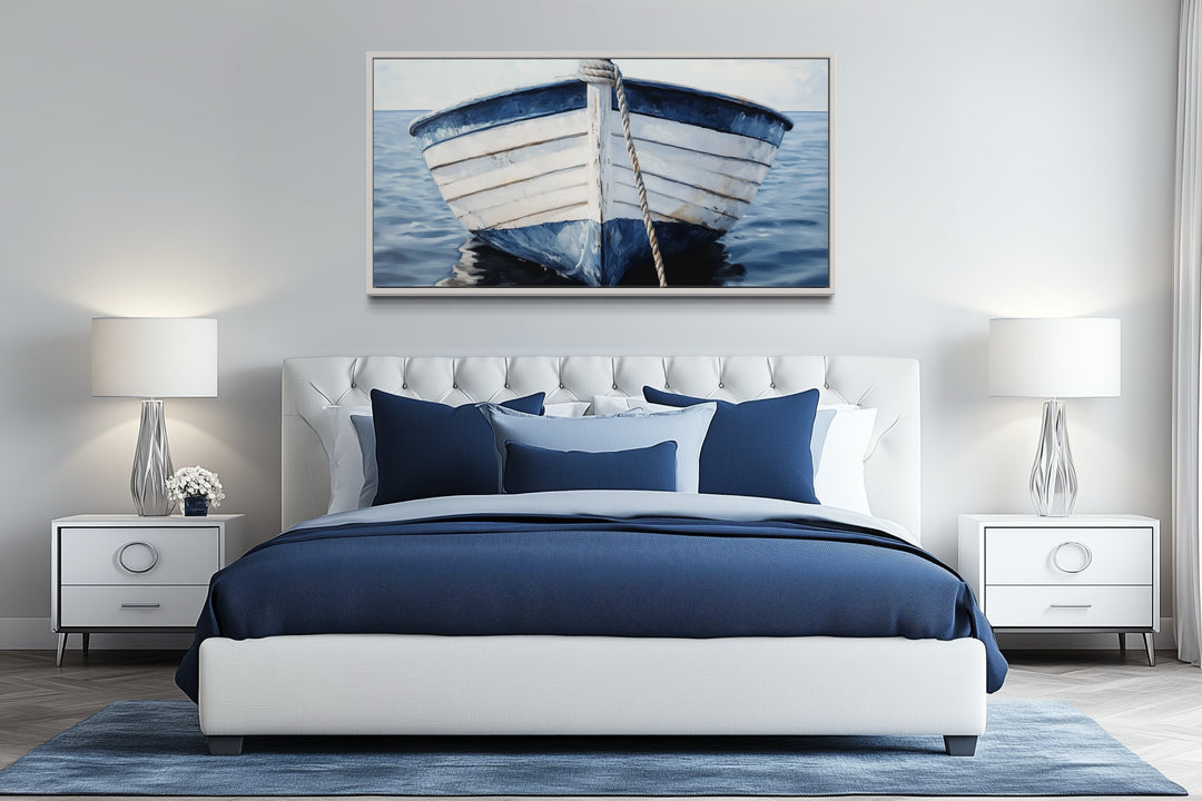 Rustic blue and white boat canvas wall art hanging above a modern bed in a coastal bedroom.
