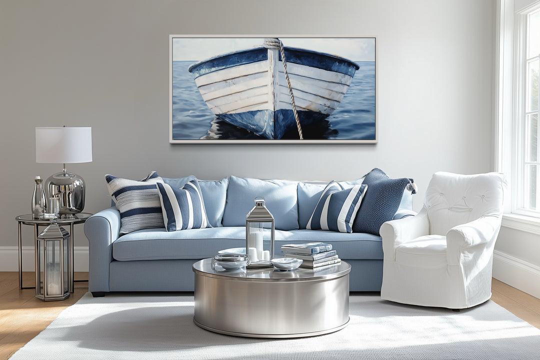 Rustic boat wall art featuring a blue and white nautical canvas print above a blue sofa.