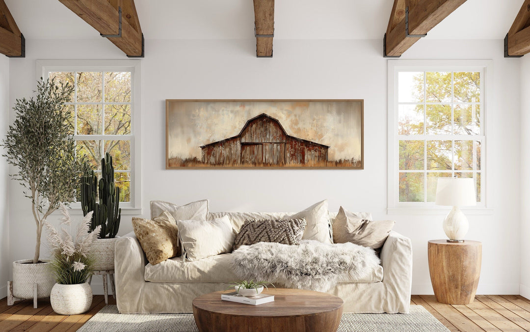 Rustic brown barn panoramic framed canvas wall art hanging above a sofa in a farmhouse living room.