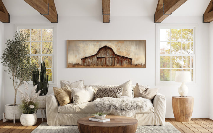 Rustic brown barn panoramic framed canvas wall art hanging above a sofa in a farmhouse living room.