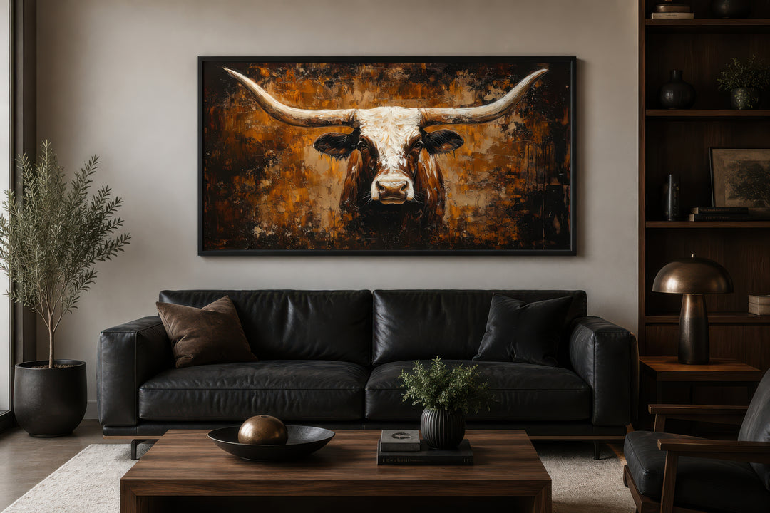 Rustic brown longhorn bull painting on an abstract western background canvas wall art above a sofa.