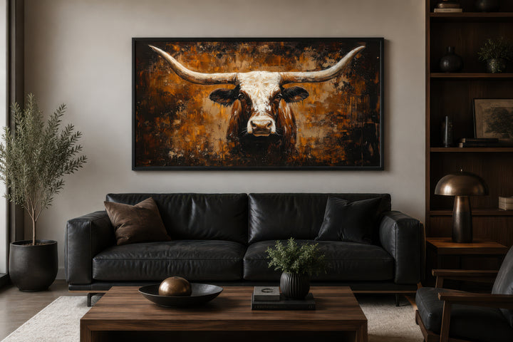 Rustic brown longhorn bull painting on an abstract western background canvas wall art above a sofa.