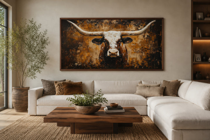 A large horizontal canvas painting of a longhorn bull on an abstract brown and gold background.