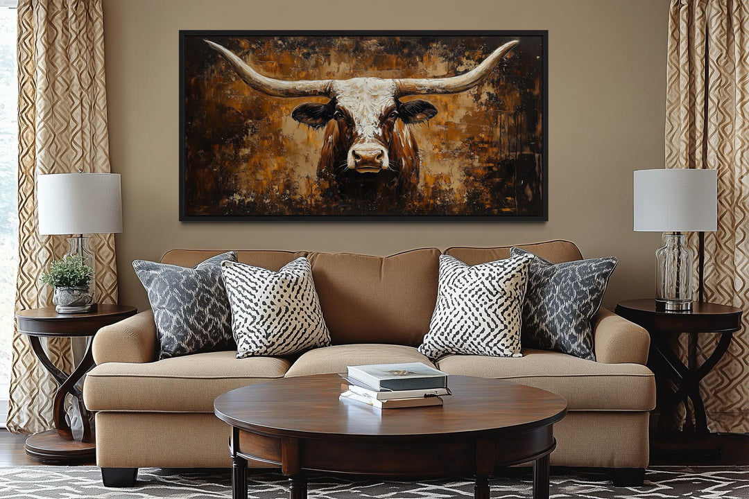 Rustic longhorn bull painting on an abstract western background canvas wall art above a sofa.