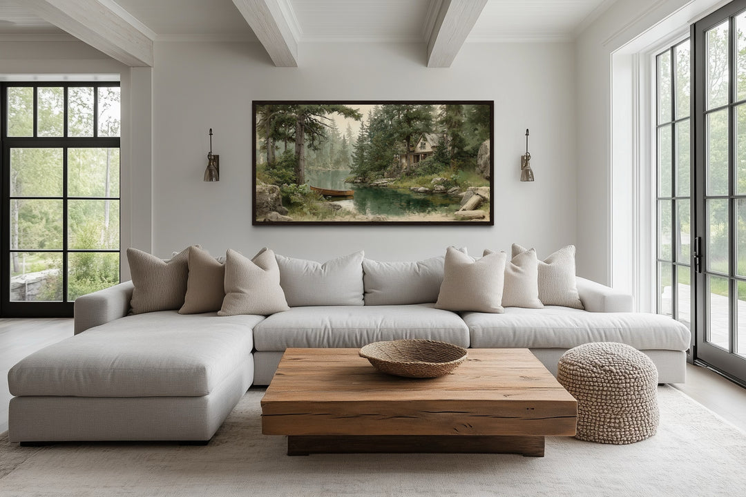 Panoramic framed painting of a wooden boat on a serene lake, hung above a modern sectional sofa.
