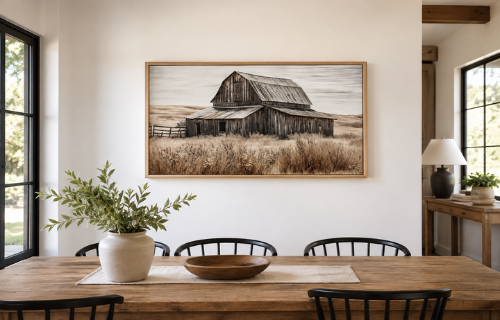 Rustic chic old farm barn painting on wood framed canvas wall art in a farmhouse dining room.