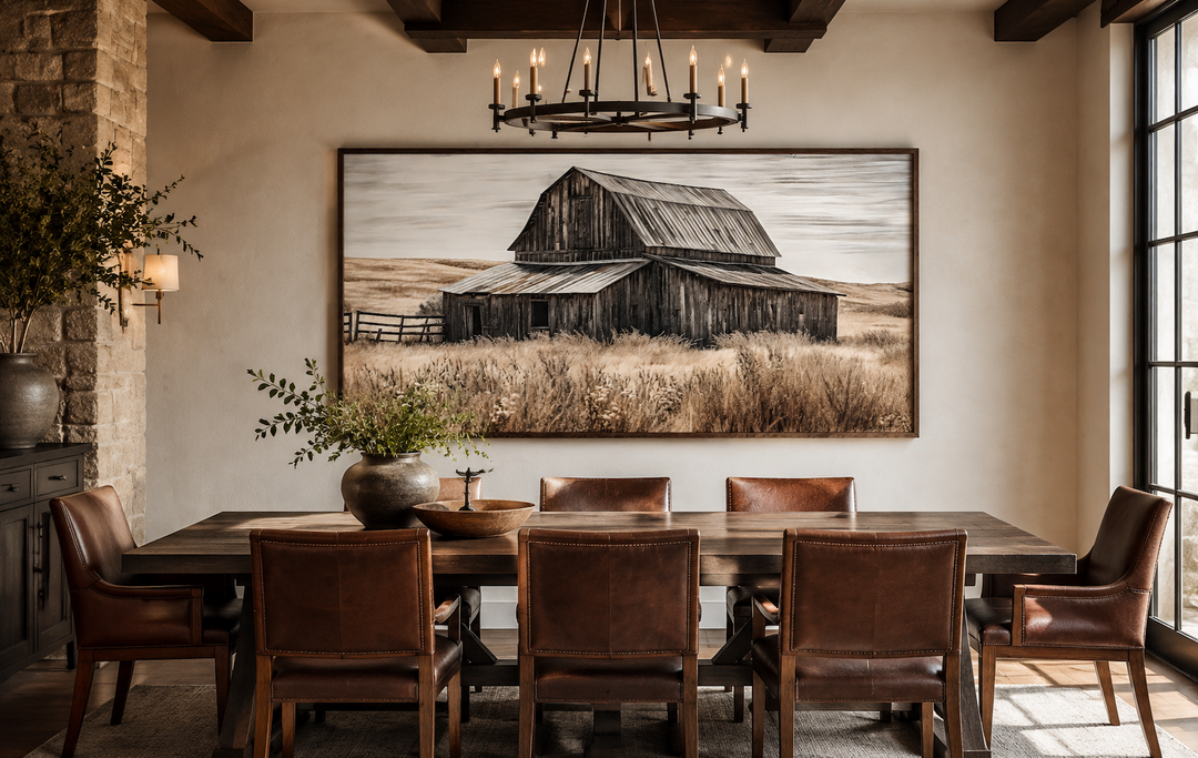 Rustic chic old farm barn painting on wood framed canvas wall art above a wooden dining table.