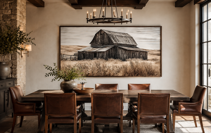 Rustic chic old farm barn painting on wood framed canvas wall art above a wooden dining table.
