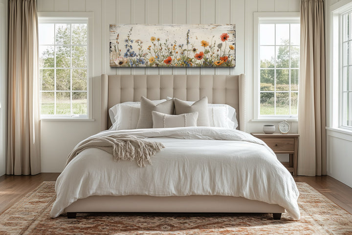 Rustic long narrow wall art featuring colorful wildflowers over a bed in a farmhouse bedroom.