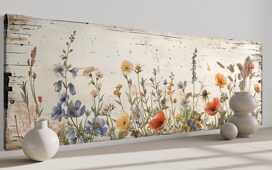 Rustic long narrow wall art featuring colorful wildflowers on a distressed whitewashed background.
