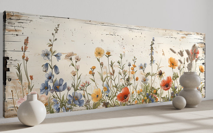Rustic long narrow wall art featuring colorful wildflowers on a distressed whitewashed background.