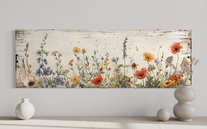 Rustic long narrow wall art featuring colorful wildflowers on a distressed whitewashed background.