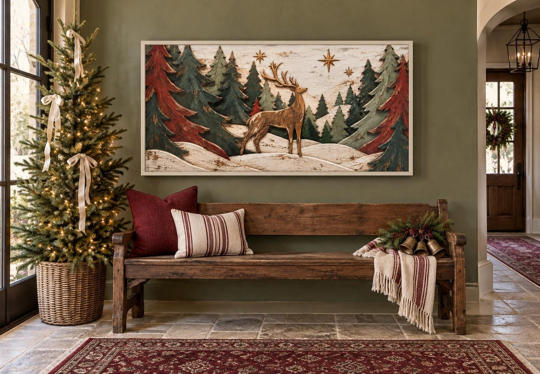 Rustic framed canvas art of a stag among red and green evergreen trees in a snowy forest.