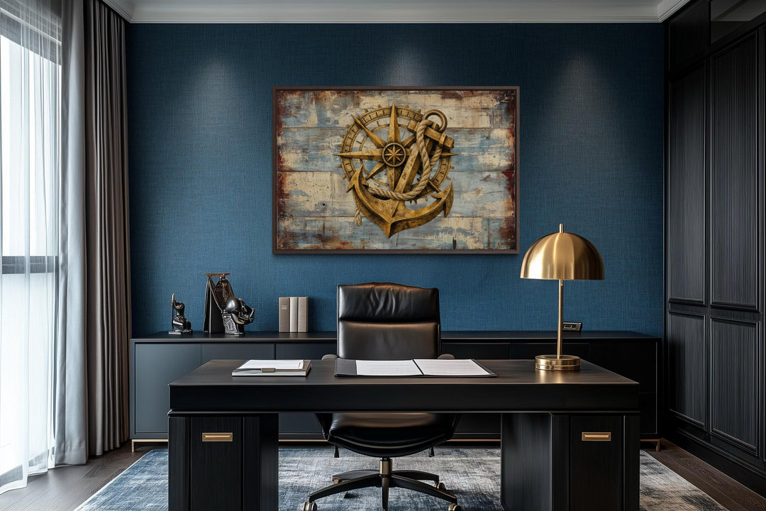 Rustic compass and anchor canvas wall art on a weathered blue wood background in a modern office.