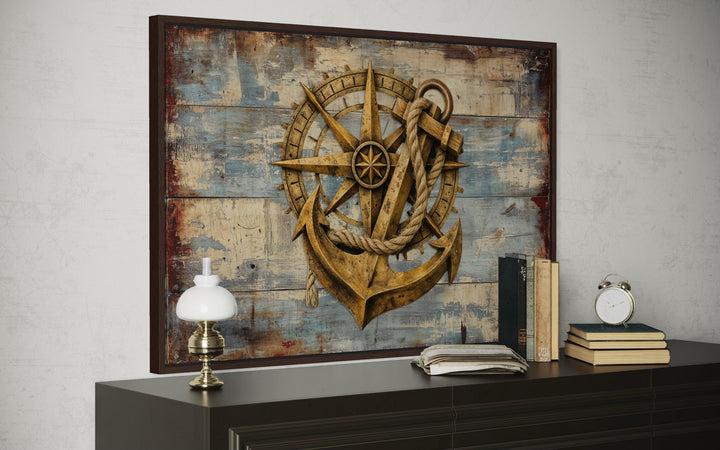 Rustic compass and anchor canvas wall art on weathered blue wood planks.