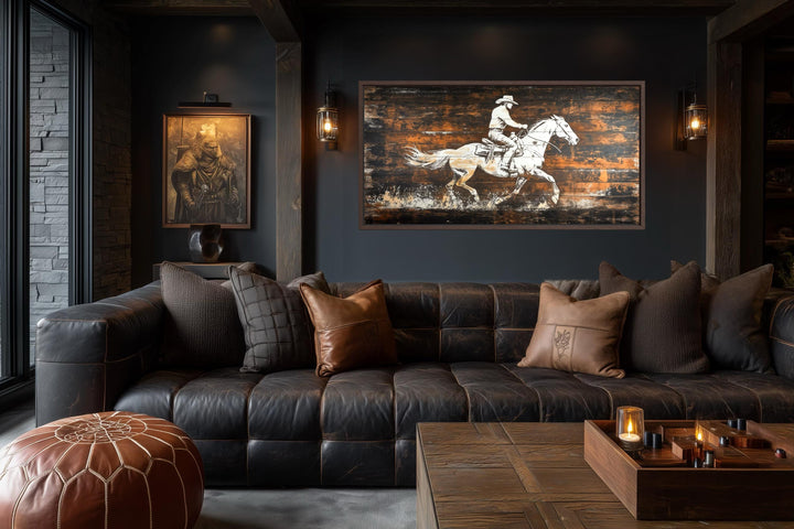 Rustic cowboy on horse on wood planks canvas wall art in a dark, modern western living room.