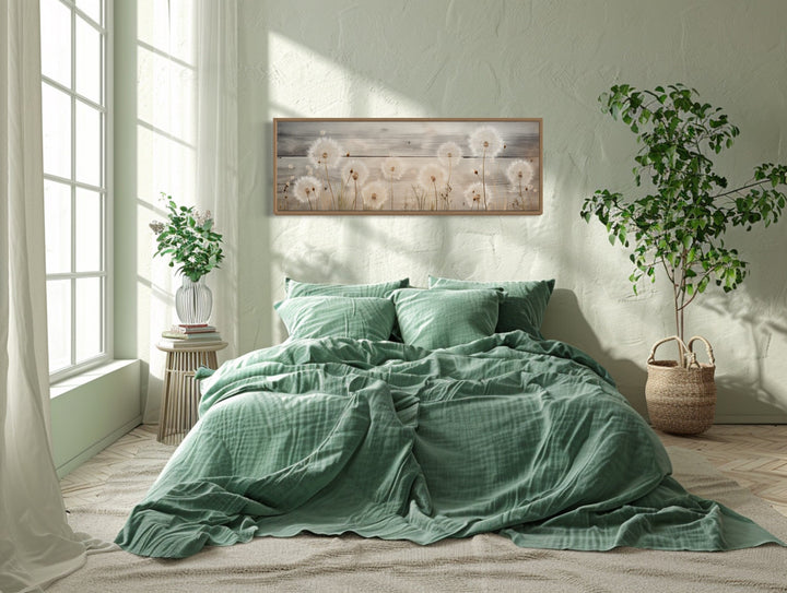 Rustic dandelions painting on wood, long horizontal framed wall art hanging above a bed.