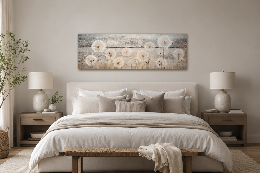 Long horizontal dandelion painting on wood texture hanging above a bed in a neutral bedroom.