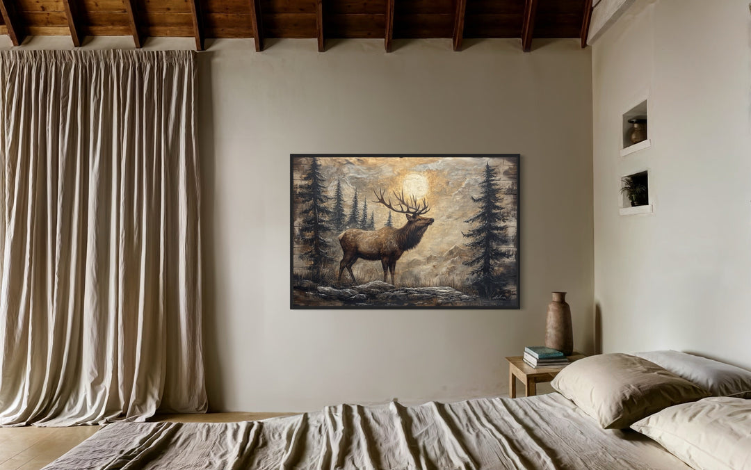 Rustic framed canvas wall art of an elk in a winter forest, displayed in a cozy bedroom setting.