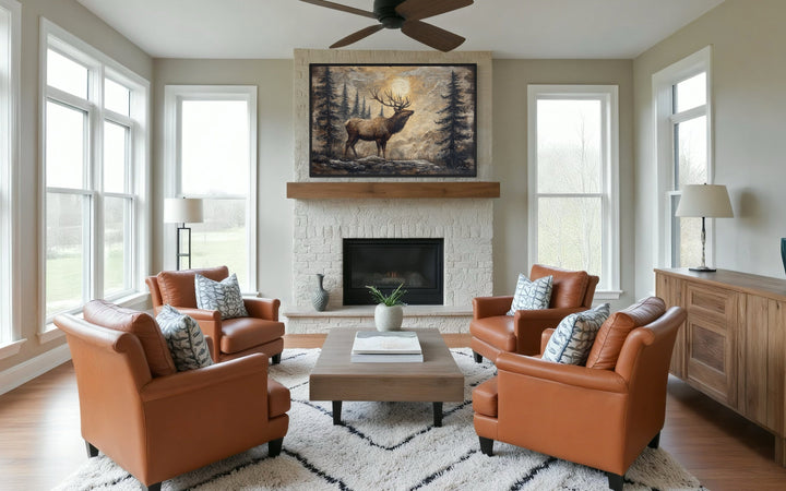 Rustic elk in winter forest painted on wood framed canvas wall art above a stone fireplace.