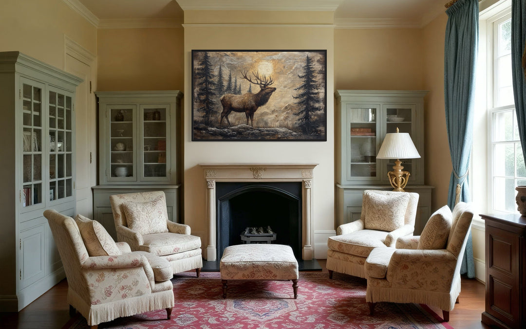 Rustic elk in winter forest painted on wood framed canvas wall art hanging above a fireplace.