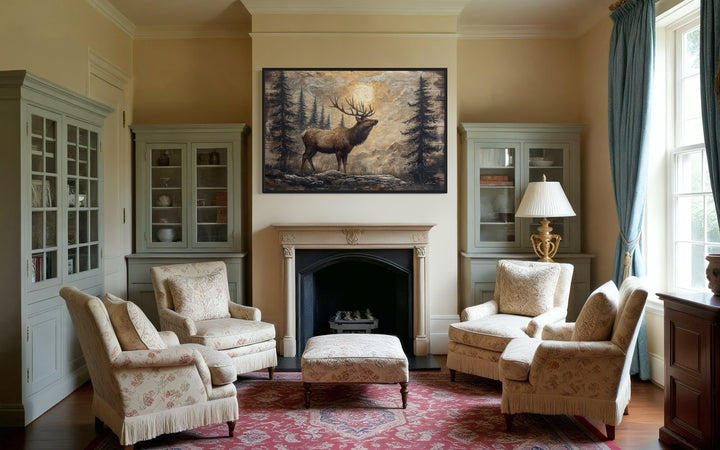Rustic elk in winter forest painted on wood framed canvas wall art hanging above a fireplace.