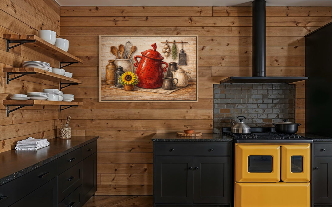 Rustic farmhouse kitchen wall art featuring a red ceramic pot and utensils on a wooden wall.