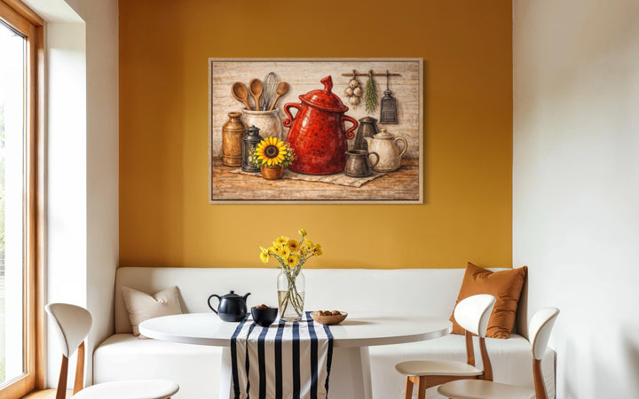 Rustic farmhouse kitchen wall art featuring a red ceramic pot and utensils on a yellow wall.