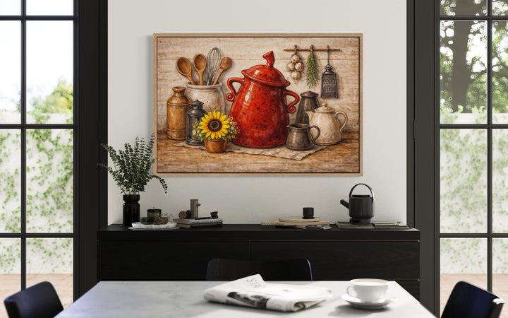 Rustic farmhouse kitchen wall art featuring a red ceramic pot and utensils on a wooden surface.