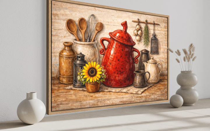 Framed rustic farmhouse kitchen wall art featuring a red ceramic pot, utensils, and a sunflower.