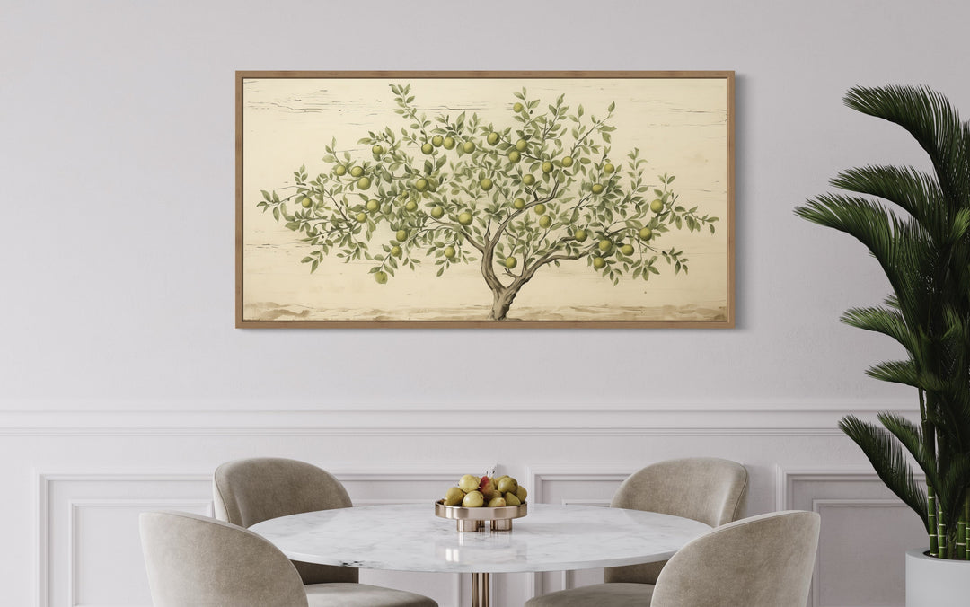 Rustic farmhouse apple tree canvas wall art in a wooden frame above a marble dining table.