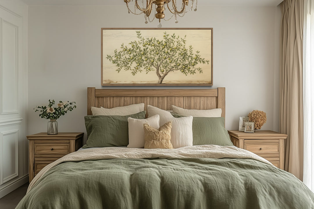 Rustic farmhouse wall art featuring a green apple tree canvas in a wooden frame above a bed.