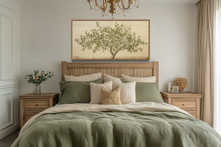 Rustic farmhouse wall art featuring a green apple tree canvas in a wooden frame above a bed.