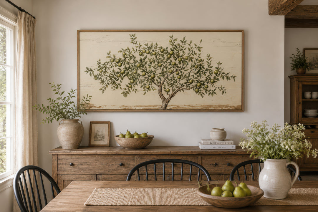 Rustic farmhouse wall art featuring a painted apple tree on canvas above a wooden sideboard.