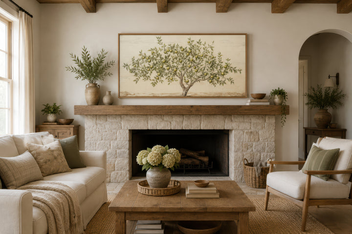 Framed rustic apple tree canvas wall art hanging above a fireplace in a farmhouse living room.