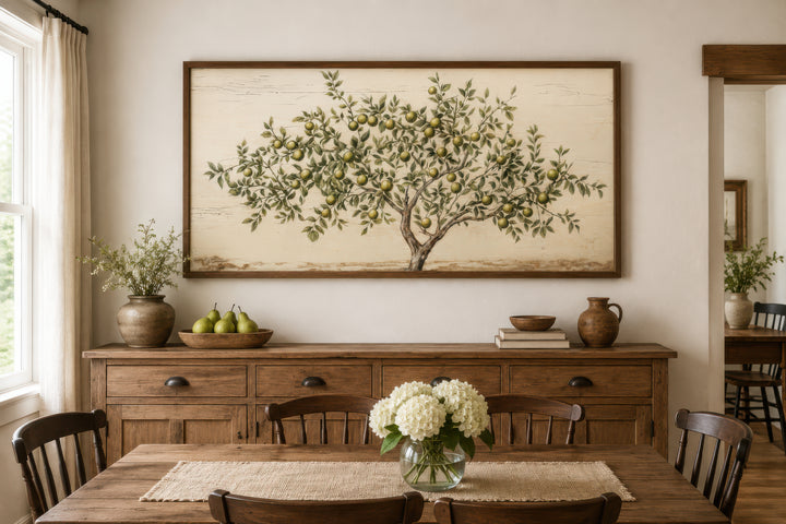 Rustic farmhouse wall art featuring a painted apple tree on canvas above a wooden sideboard.